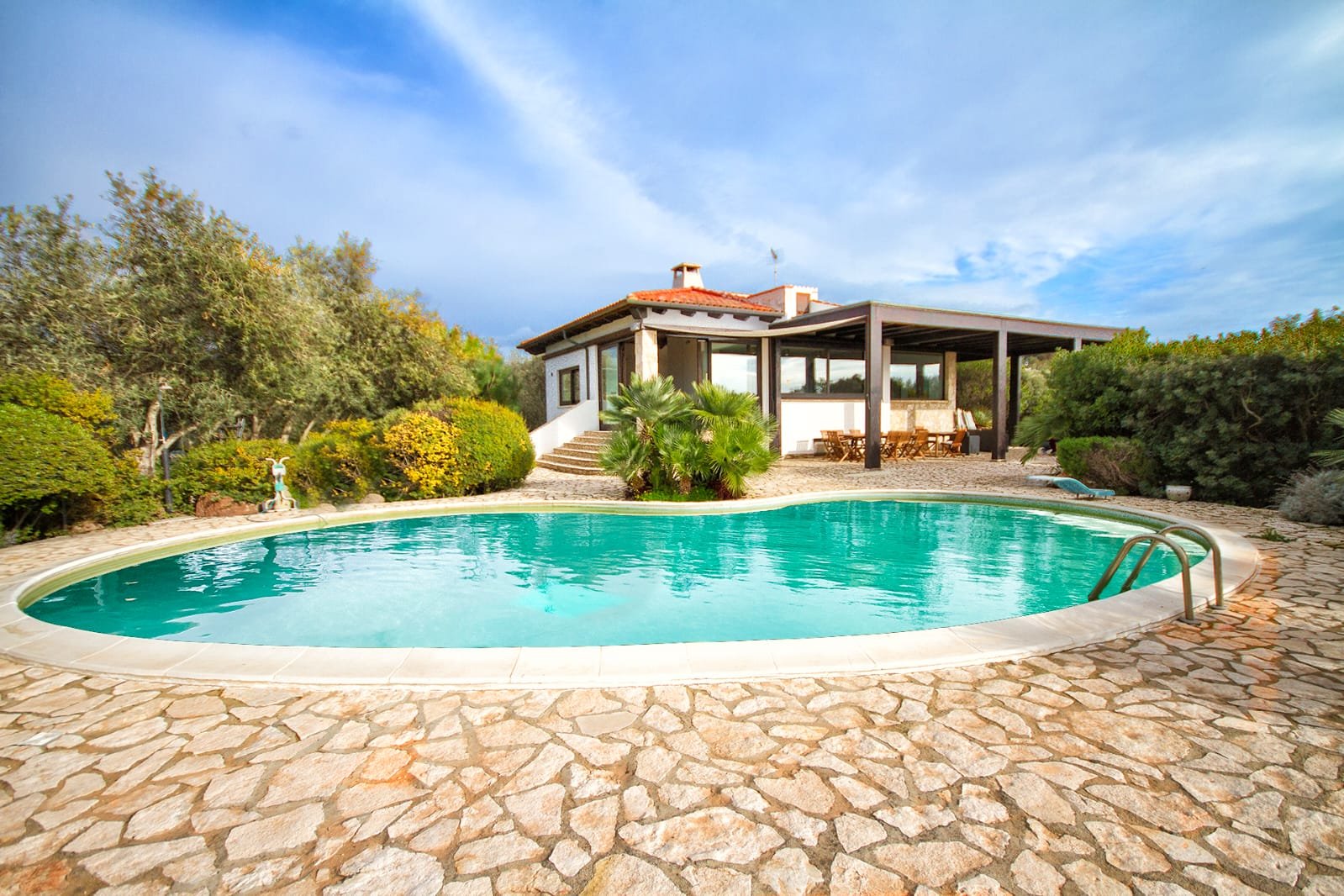 Private pool and villa surrounded by Mediterranean greenery
